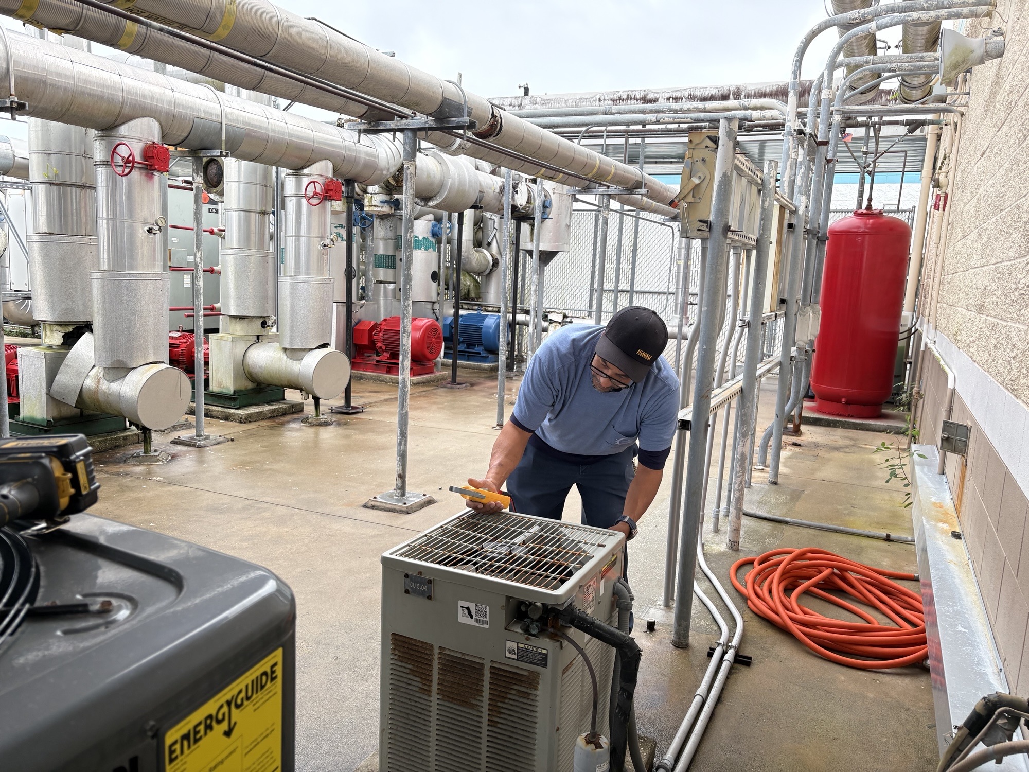 Commercial air conditioning technician servicing rooftop AC equipment in Brevard County Florida
