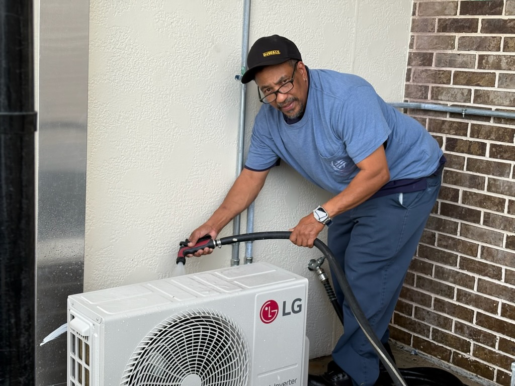 Air conditioning technician servicing an outdoor AC unit in Brevard County Florida